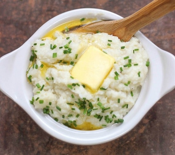 Faux Cauliflower Mashed Potatoes in a bowl with butter on top
